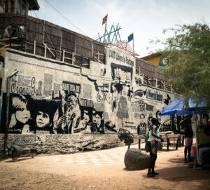A vibrant street mural in Senegal depicting urban life and artistic expression.